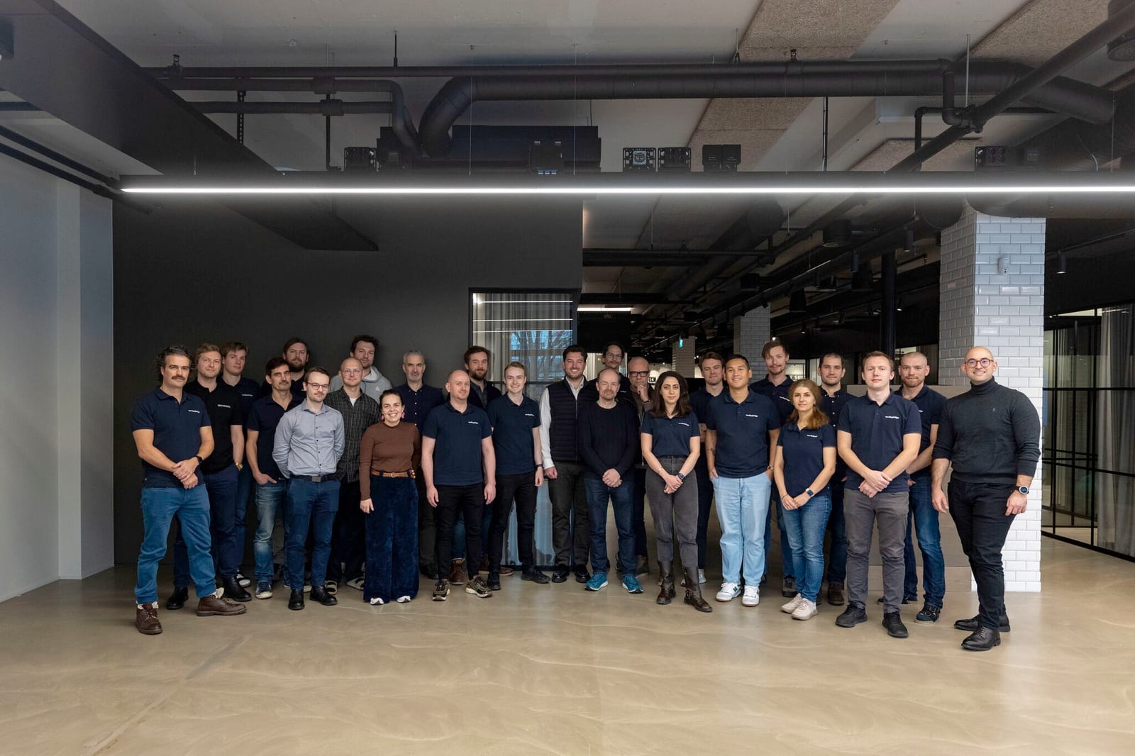 The Muybridge team, around thirty people, standing together in their office