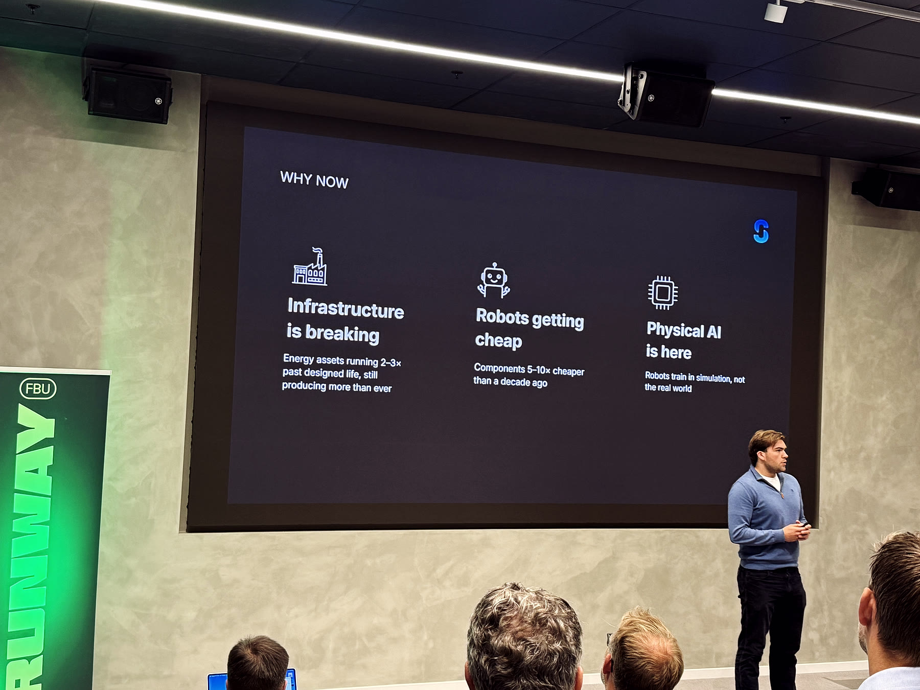 Kristian Romen from Saro Robotics presenting a ‘Why now’ slide covering ageing infrastructure, cheaper components and the arrival of physical AI.